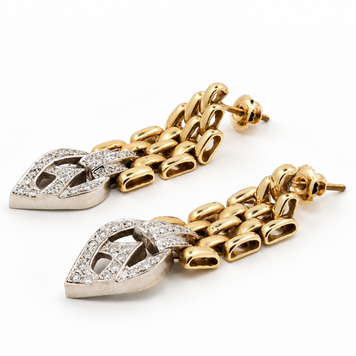 Angled view of articulated gold and natural diamond drop earrings