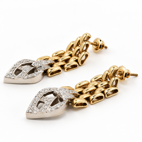 Angled view of articulated gold and natural diamond drop earrings